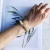 Sagacity bracelet from EBIG Jewel on marble with photo of leaves