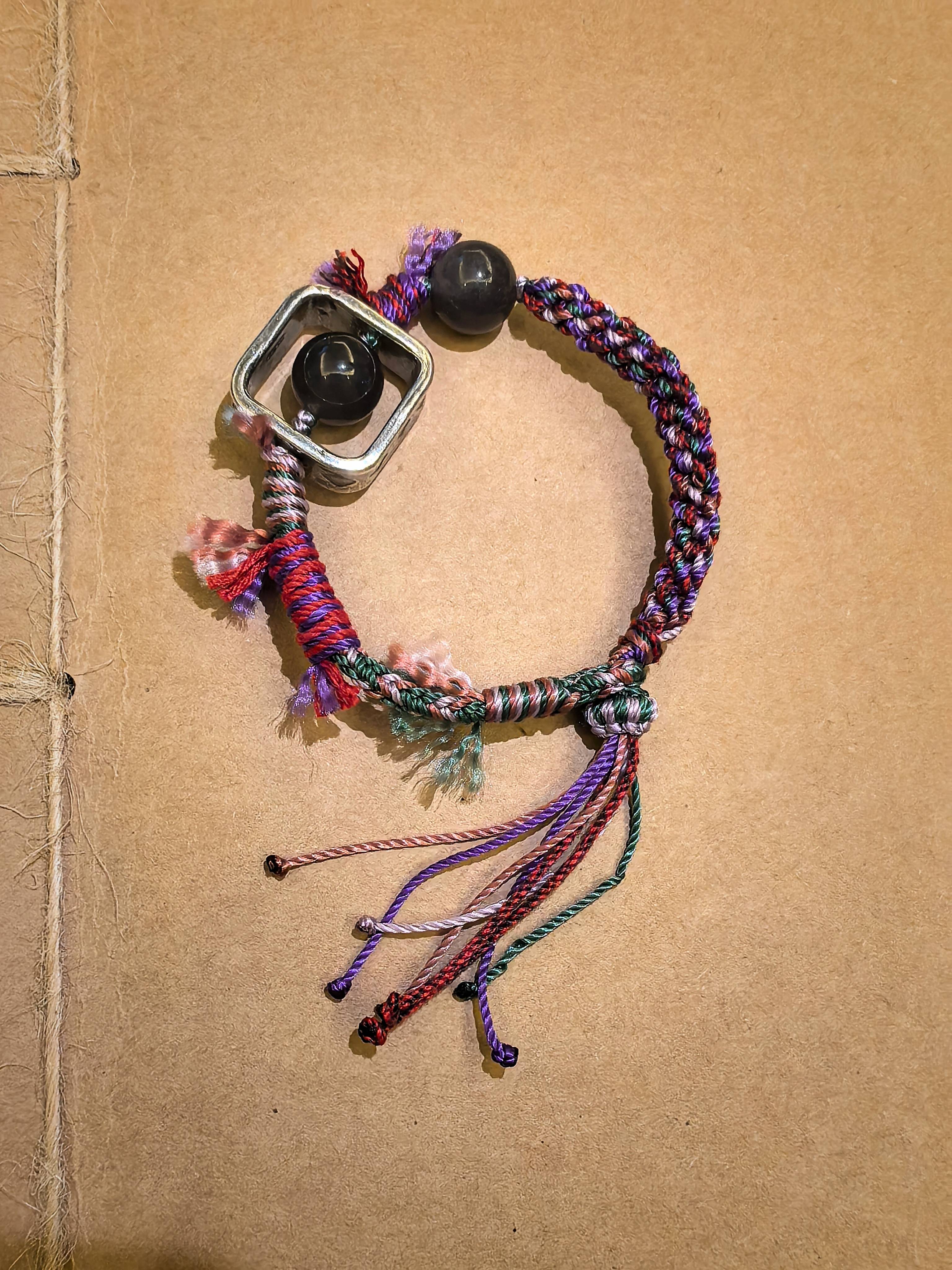 Brilliance bracelet from EBIG Jewel placed against brown paper with twine.